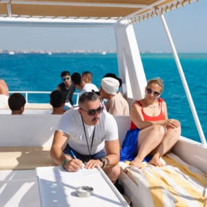 A group of snorkelers enjoying the stunning underwater world in Hurghada, near vibrant coral reefs.