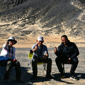 Tourists climbing volcanic mountain in Black Desert
