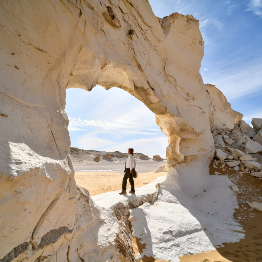 White Desert safari jeep crossing golden sand dunes